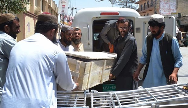 Pakistani security officials and hospital staff move a body into a morgue in Quetta on Sunday, transported to the hospital following a drone strike in the remote town of Ahmad Wal in Balochistan.