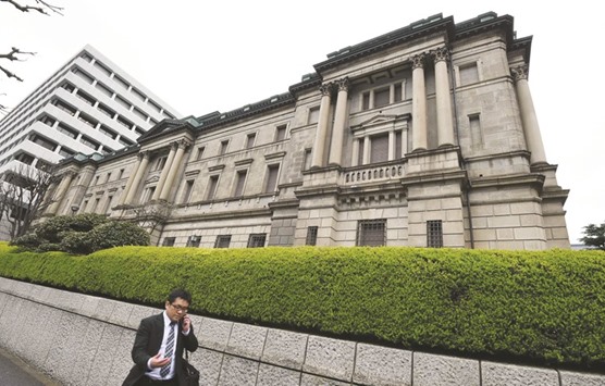 A businessman walks past the headquarters of the Bank of Japan in Tokyo. With central banks in Japan and Europe holding interest rates below zero in a bid to boost their moribund economies, overseas funds are contributing to the flood of money coming into the $3.7tn municipal market where local governments borrow to build roads, bridges and schools.