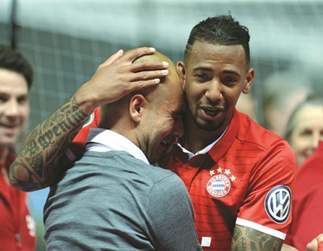 Bayern Munich defender Jerome Boateng comforts coach Pep Guardiola who broke down after his final game in charge. (AFP)