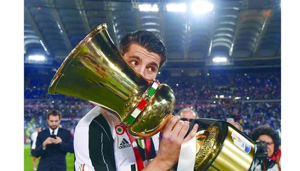 Juventusu2019 Spanish forward Alvaro Morata kisses the trophy after beating AC Milan in the final of the Italian Cup in Rome. (AFP)
