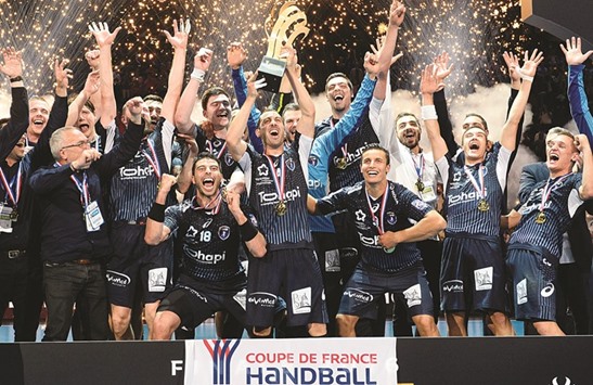 Montpellier players celebrate after winning the Handball French Cup final against Paris Saint-Germain (PSG) at the Bercy-Accor Hotels Arena stadium in Paris on Saturday. (AFP)
