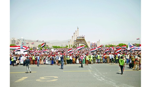 People wave Yemenu2019s national flag during a ceremony marking Yemenu2019s Reunification Day in Sanaa yesterday.