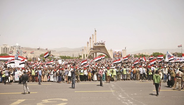 People wave Yemenu2019s national flag during a ceremony marking Yemenu2019s Reunification Day in Sanaa yesterday.
