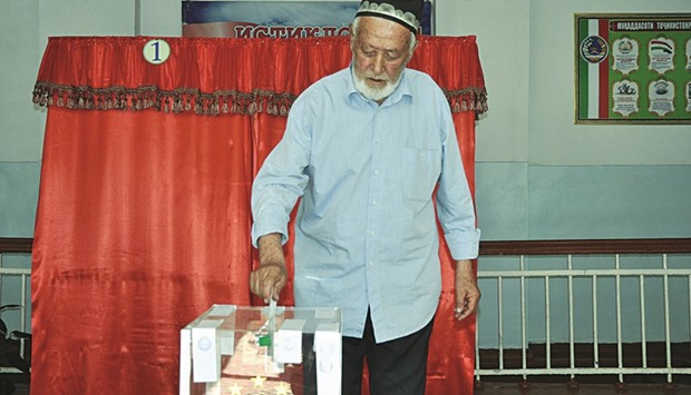An elderly Tajik man casts his ballot yesterday in Dushanbe