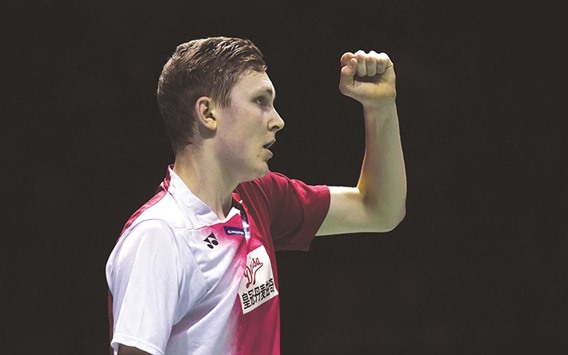 Viktor Axelsen of Denmark celebrates his victory over Tommy Sugiarto of Indonesia in their menu2019s singles final group match at the Thomas Cup badminton tournament.