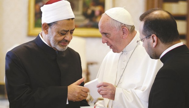 Pope Francis exchanges gifts with Egyptian Imam of the Al Azhar Mosque Sheikh Ahmed Mohamed el-Tayeb during a private meeting at the Vatican yesterday.