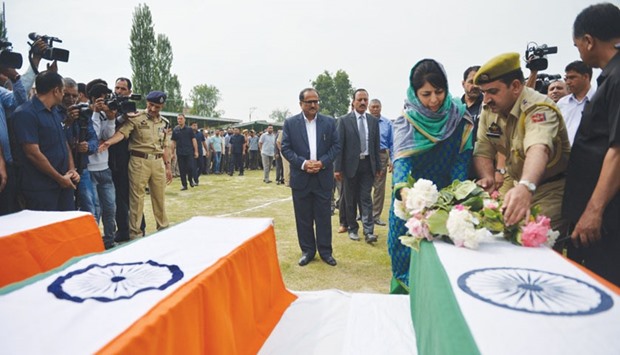 Jammu and Kashmir Chief Minister Mehbooba Mufti lays a wreath on the coffin of a police officer during a ceremony in Srinagar yesterday after an attack by suspected militants.