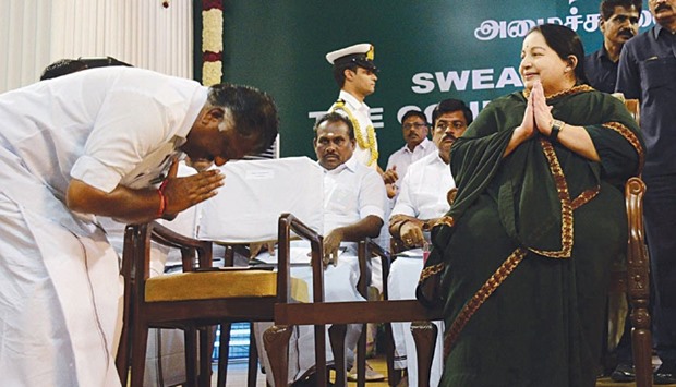 AIADMK leader O Panneerselvam bows before party chief secretary J Jayalalithaa during the swearing-in ceremony at the Madras University auditorium in Chennai yesterday.