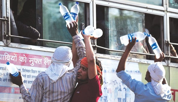 Vendors sell bottles of drinking water to passengers at a bus stop on a hot day in Allahabad. India is bracing for another bout of extreme heat after temperatures smashed records in some parts of the country.