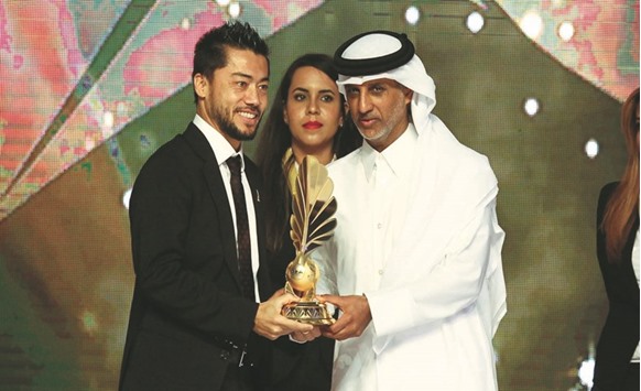 Rodrigo Tabata receives Player of the Year award from QFA president Sheikh Hamad bin Khalifa bin Ahmad al-Thani.