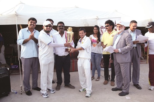 Metabo skipper Abdul Kadar and teammate Atiq receive the winnersu2019 trophy from M Pallonji regional general manager Chidananda Nayak after winning 2nd M Pallonji Cricket Tournament-Division II.