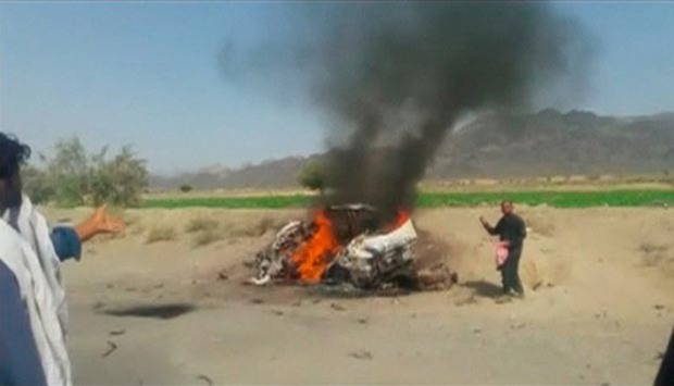 A car is seen on fire at the site of a drone strike believed to have killed Afghan Taliban leader Mullah Akhtar Mansour in southwest Pakistan in this still image taken from video.