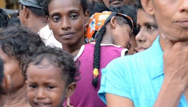 Sri Lankan flood affected residents line up to receive food in the Colombo suburb of Kaduwela on Tuesday.