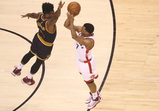 Kyle Lowry (right) of the Toronto Raptors shoots a three point basket in the first half against Iman Shumpert of the Cleveland Cavaliers in game four of the Eastern Conference Finals during the 2016 NBA Playoffs at the Air Canada Centre in Toronto. (Getty Images/AFP)