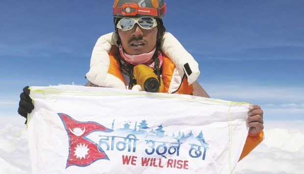 Nepalese mountaineer Phurba Tenjing Sherpa unfurling a flag on top of Mount Everest on May 20. Phurba reached the summit of Mount Everest for the 10th time carrying the flag to tell the world that Nepal will rise up from the devastation of the massive earthquake of April-May, 2015.