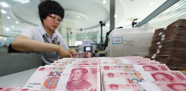 A teller counts yuan notes in a bank in China. The yuan is down 1.2% this month amid rising odds of a Federal Reserve interest-rate increase in June, a sustained retreat that hasnu2019t been seen since a January slide spurred a worldwide rout in equities.