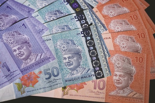 Malaysian ringgit banknotes of various denominations are arranged for a photograph in Tokyo. Ringgitu2019s top forecaster ING sees a 10% jump by September 30 based on closing prices yesterday.