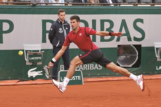 Serbiau2019s Novak Djokovic in action against Yen-Hsun Lu of Taiwan during their first round French Open match at Roland Garros in Paris yesterday. (Reuters)