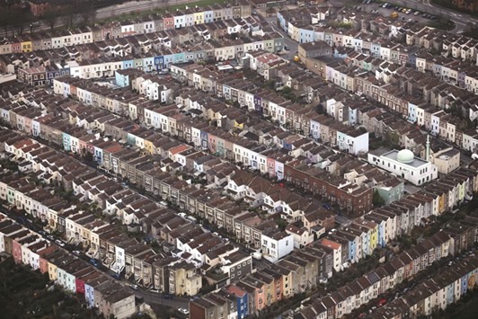 A mosque, right, stands among rows of painted residential houses in this aerial photograph taken over Bristol, UK, on December 17, 2015. In the UK, the idea of a rent-to-own scheme technically based on the long-established Islamic contract of ijara came up last year when the Liberal Democrats party proposed such a model for less wealthy Londoners for whom home ownership is normally out of reach due to sky-high real estate prices.