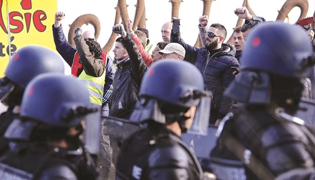 Police take up positions after striking workers blockaded roads near the refinery at Fos-sur-Mer, Marseille.