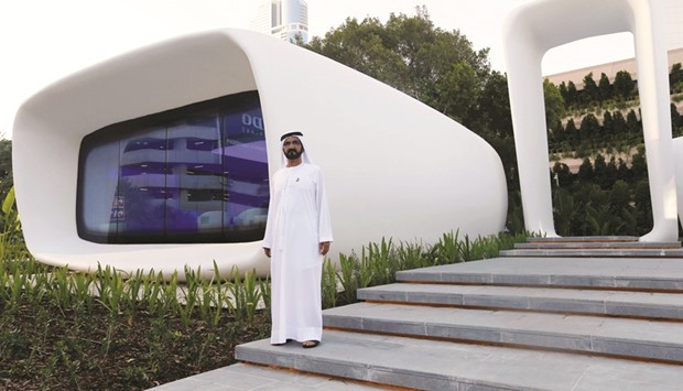 Sheikh Mohamed bin Rashid al-Maktoum, Vice-President and Prime Minister of the UAE and Ruler of Dubai, stands in front of the worldu2019s first functional 3D printed offices during the official opening in Dubai on Monday.
