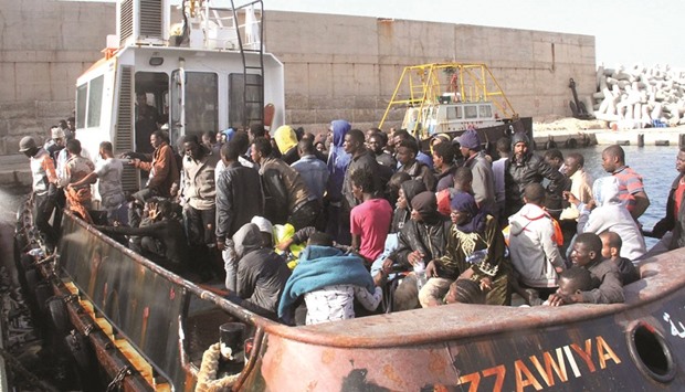 Illegal African migrants arrive by boat at the Zawiyah port, a Libyan naval base some 45km west of Tripoli, after they were rescued off the western city of Sabratha yesterday as they were trying to reach Europe by boat.