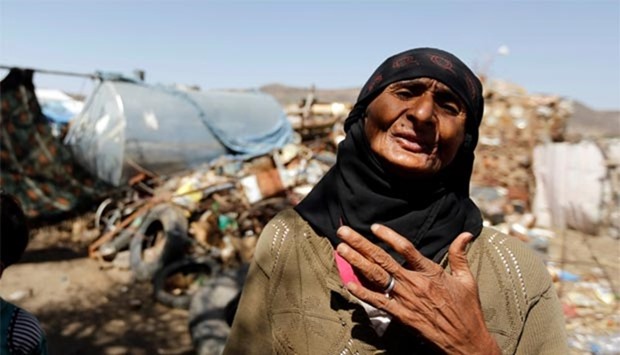A woman reacts outside her hut at a camp for internally displaced people near Sanaa.