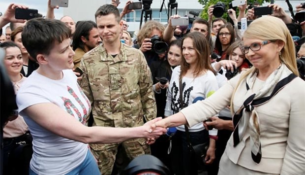 Ukrainian servicewoman Nadiya Savchenko shakes hands with former Ukrainian prime minister and leader of Batkivshchyna (Fatherland) party Yulia Tymoshenko at Boryspil International airport outside Kiev on Wednesday.
