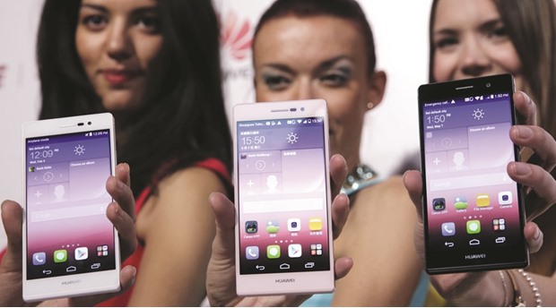 Models hold Huaweiu2019s new smartphone, the Ascend P7, during a presentation in Paris. The Chinese firm has filed lawsuits in the United States and China seeking compensation for what it said was unlicensed use of fourth-generation (4G) cellular communications technology, operating systems and user interface software in Samsung phones.