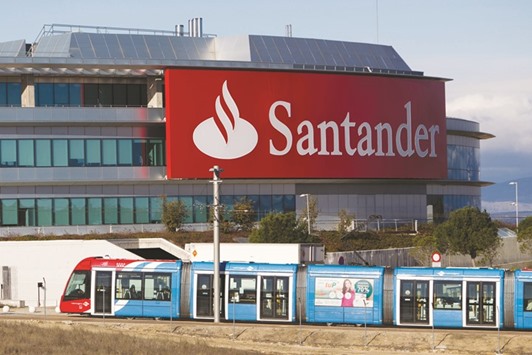 A city train passes the headquarters of Banco Santander  in Madrid. Shares of Santander soared 6.1% yesterday.