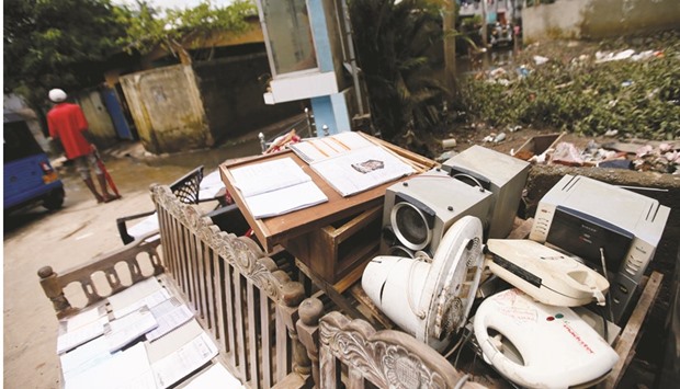Electronic items, that were caught in the floods, drying on chairs near a house in Wellampitiya,  near Colombo, yesterday.