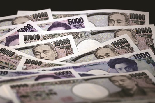 Japanese yen banknotes of various denominations are arranged for a photograph in Tokyo. The yen has depreciated in each of the four previous years, a record losing streak, driven largely by two rounds of quantitative easing.