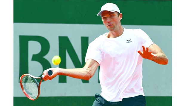 Croatiau2019s Ivo Karlovic returns the ball to Australiau2019s Jordan Thompson during their menu2019s second round match at the French Open in Paris yesterday. (AFP)