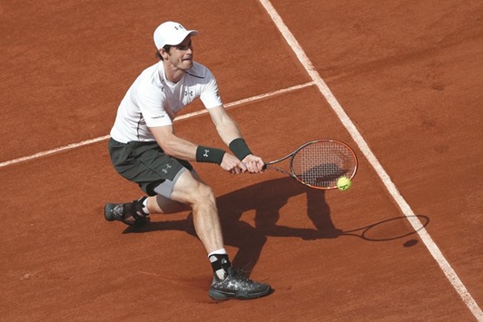 Great Britainu2019s Andy Murray returns the ball to Franceu2019s Mathias Bourgue during the menu2019s second round match at the French Open in Paris yesterday. (AFP)