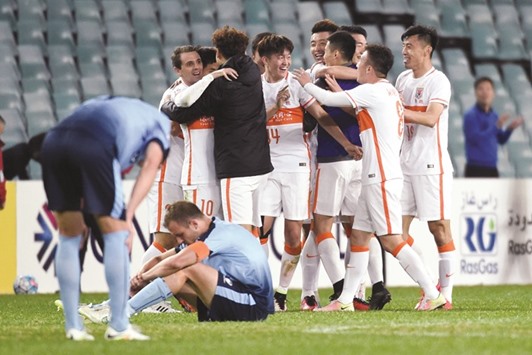 Shandong Luneng players celebrate their win over Sydney FC after the final whistle in AFC Champions League round of 16 second leg match in Sydney yesterday. (AFP)