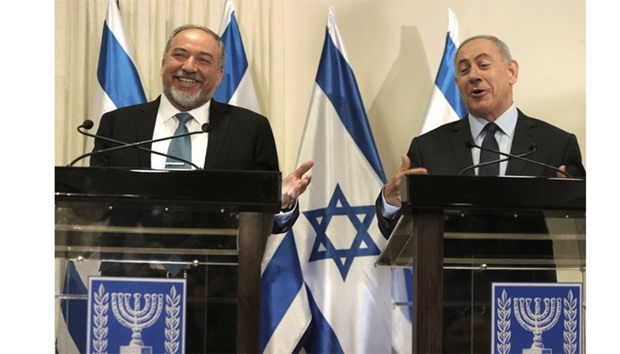 Israeli Prime Minister Benjamin Netanyahu and Avigdor Lieberman (left), the head of hardline nationalist party Yisrael Beitenu, are seen during a ceremony in which they signed a coalition agreement yesterday at the Knesset in Jerusalem.