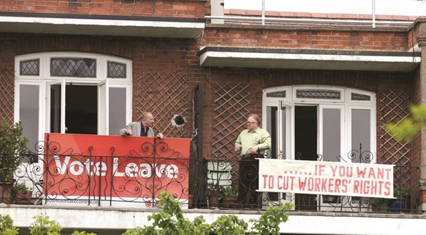 Neighbours Tony (left) and Frank pose for cameras after hanging rival EU referendum banners from their balconies in north London.