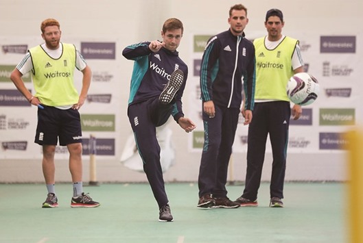 England all-rounder Chris Woakes kicks a ball as his teammates look on during the training session in Chester-le-Street, north east England yesterday. (Reuters)