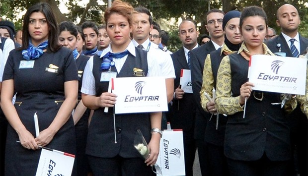 EgyptAir flight attendants take part in a march near the Cairo Opera House in the Egyptian capital on May 26, 2016, for the 66 victims of the EgyptAir MS804 flight that crashed in the Mediterranean Sea.