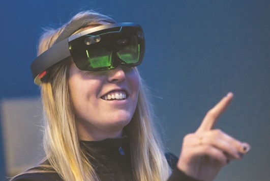 An employee demonstrates the Microsoft Corp HoloLens augmented reality (AR) viewer at the Microsoft Developers Build Conference in San Francisco on March 30. This year, when Microsoft showed off an early edition of its HoloLens augmented-reality goggles, it targeted the software developers it needs to make the device useful.