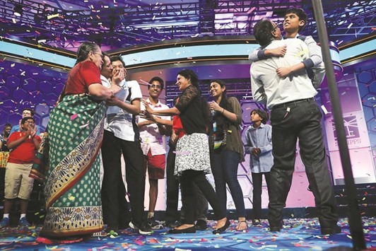 Spellers Nihar Saireddy Janga (right) of Austin, Texas and Jairam Jagadeesh Hathwar (third left) of Painted Post, New York, celebrate with family members after the finals of the 2016 Scripps National Spelling Bee in National Harbor, Maryland. Both spellers were declared co-champions at the end of the annual Spelling competition.