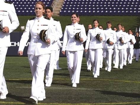 Midshipmen 1st Class walk to their seats during graduation ceremonies at the US Naval Academy in Annapolis, Maryland, yesterday. This is the first year that females are required to wear the same uniform as the males. US Secretary of Defence Ashton Carter was this yearu2019s commencement speaker.