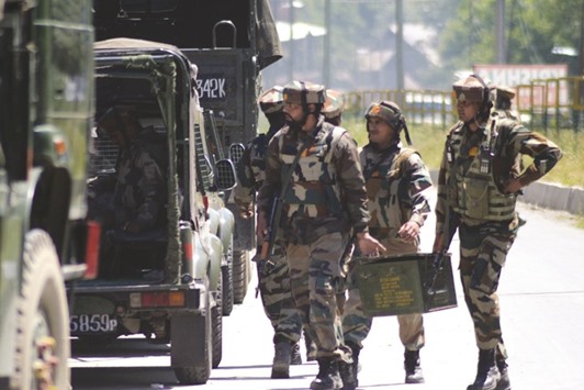 Soldiers surround an area during a gunfight with militants in Kunzar Tangmarg in Jammu and Kashmiru2019s Baramulla district yesterday. At least six militants and a soldier were killed in two separate Kashmir gun battles yesterday amid flared up terrorist activities in the valley following increased levels of infiltration from across the border, officials said.