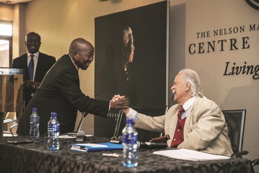 Close friend and legal adviser to Nelson Mandela, George Bizos, congratulates Maponiya (left) during the public announcement of the distribution of all cash bequests made in terms of the Will of Nelson Mandela, at the Mandela Foundation in Johannesburg.