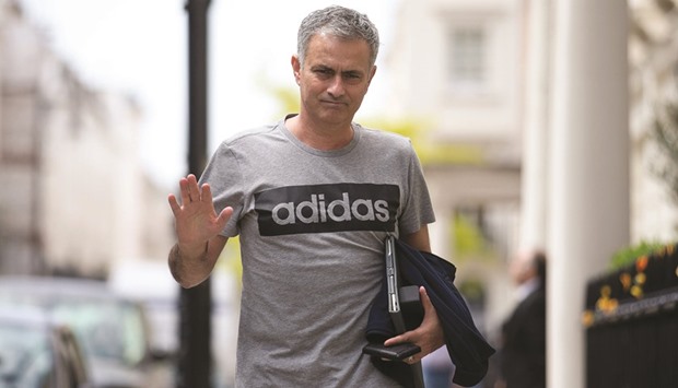 Manchester Unitedu2019s new Portuguese manager Jose Mourinho waves as he returns to his home in central London yesterday.