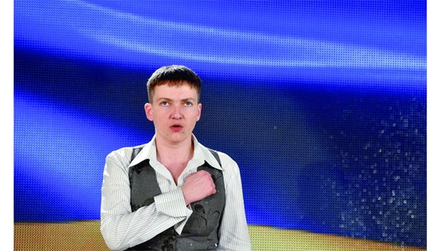 Savchenko singing national anthem during a press conference in Kiev.
