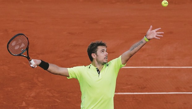 Switzerlandu2019s Stan Wawrinka serves the ball during his French Open match against Franceu2019s Jeremy Chardy at Roland Garros in Paris yesterday. (Reuters)
