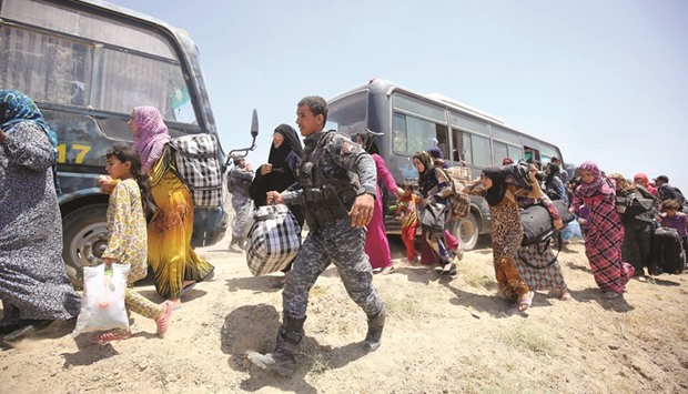 Iraqi forces help families near Al Sejar village, in Iraqu2019s Anbar province, after fleeing the city of Fallujah yesterday, during a major operation by pro-government forces to retake the city of Fallujah, from the Islamic State (IS) group.