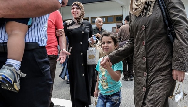 A Syrian migrant family arrives at Subang Air Force base in Subang, outside Kuala Lumpur.