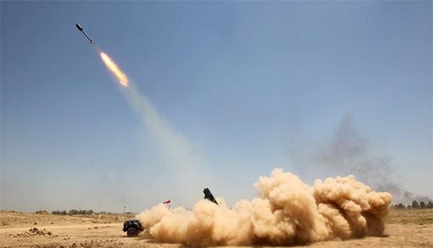 Pro-government forces fighters fire a rocket in al-Sejar village, in Iraq's Anbar province, as they take part in a major assault to retake Falluja from Islamic State.